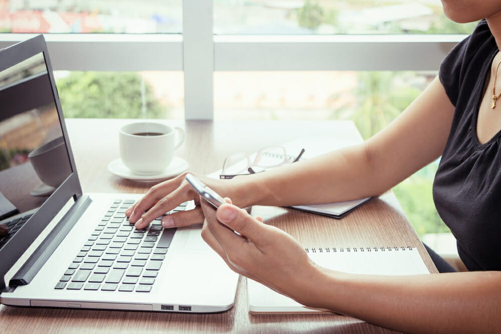 Close up of young woman home office technology