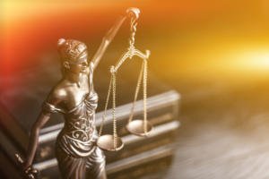 Scales of justice with gold backdrop
