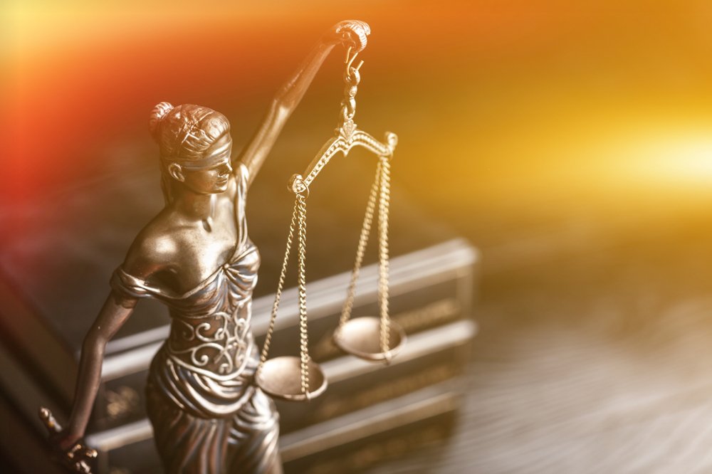 Scales of justice with gold backdrop